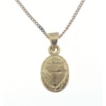 A yellow metal scarab pendant on a yellow metal chain 40cm long, weight 8.76g