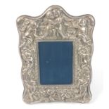 ART NOUVEAU inspired A silver photo frame decorated with cherubs, hallmarked Sheffield 1987,