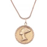 A 18ct yellow gold square chain with 750 stamped yellow gold circular pendant with Egyptian design