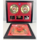 A framed QUEEN 7 inch de luxe double disc 'We are the Champions' and 'We will Rock You' frame size