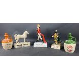 A collection of whisky advertising figurines to include White Label Dewar's Scotch Whisky, Johnnie