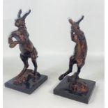 A pair of bronzed fighting HARES on plinths each standing approx 30cm tall