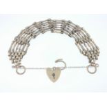 A lovely chainlink 375 stamped yellow gold bracelet (each link is stamped 375!) with heart safety