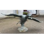 A SUBSTANTIAL heavy metal verdigris ‘duck in flight' water feature ornament with metal spout on
