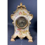 Antique brass faced clock in ceramic floral case