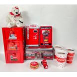 COCA-COLA memorabilia to include 3 candles, a yoyo, a diner-shaped tin, a coke-dispenser -shaped