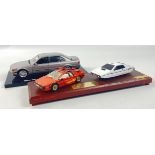 JAMES BOND - a wooden plinth with 2 iconic cars from the Spy Who Loved Me Lotus Esprit and From