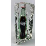 A VERY SUBSTANTIAL COCA-COLA bottle encased in an acrylic iceberg, standing approx 24cm tall