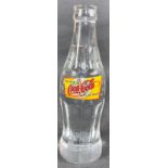 A solid glass COCA -COLA bottle with label 'World of Las Vegas', stands 19.5cm tall