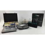 A small aluminium case with picture hanging essentials, a WERA Kraftform Micro set of precision