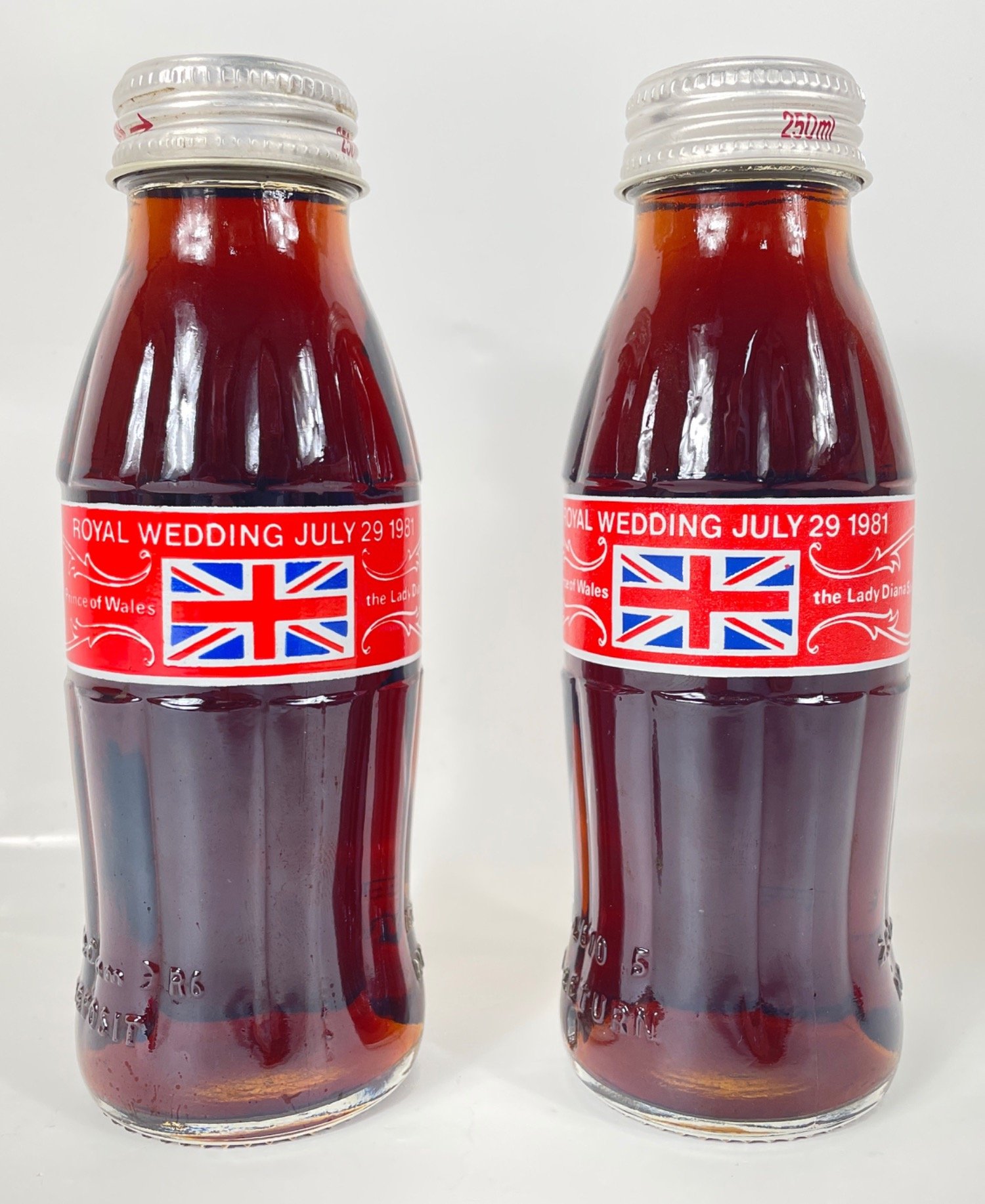 COCA-COLA - not one but two unopened souvenir 250ml bottles celebrating the royal wedding in 1981