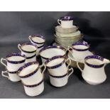 A DIAMOND china tea service with a navy and gilt trim to include 12 cups, 12 saucers, 12 plates