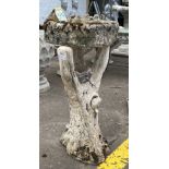 A VINTAGE ‘aged look' bird bath - standing on a stone tree effect base - the bath part is