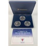 An armed forces Five Pounds triple tribute coin set within its original presentation case with the