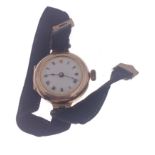 A gold lady's watch on black ribbon with 375 stamped circular watch case (2.75cm, dia), with Roman