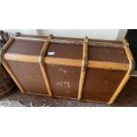 A large VINTAGE steamer travel trunk with bentwood trimmings and two heavy duty leather handles