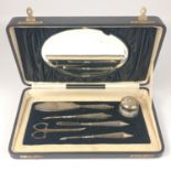A SILVER BIRMINGHAM hallmarked pedicure set within its original black silk lined box with mirrored