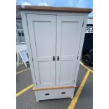 Part of a bedroom set - a two piece wardrobe with one large base drawer finished in light grey -