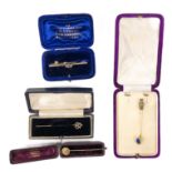 One gold tie pin 5.5cm (weight 1.15g), a sapphire and gold tie pin 6cm (weight 2.10g), a pearl and