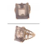 A WHOPPER of an emerald-cut smokey quartz stone mounted on an EGYPTIAN 18carat Hallmark (large