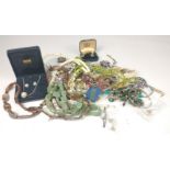 A bag of costume jewellery to include faux pearls, several brooches, strings of beads and pairs of