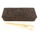 A nicely carved wooden box containing a pair of bone glove stretchers, box measures 26x10.5x5.5cm