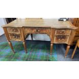 A SUBSTANTIAL antique French inspired kneehole desk with a large green distressed leather pad and