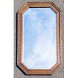 A VINTAGE octagonal oak framed mirror with carved wooden frame 80x50cm approx