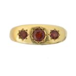 An 18ct gold garnet three stone ring,