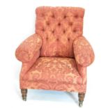 A Victorian armchair in the style of Howard & Sons