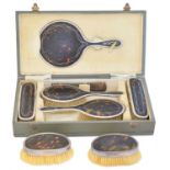 A silver and tortoiseshell dressing table set,