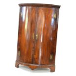 George III mahogany two-door bow front hanging corner cabinet