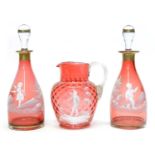 Pair of Mary Gregory cranberry glass decanters and a water jug