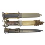 Two USM8 fighting knives and scabbards, and a FAL type C bayonet and scabbard.