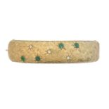 A 9ct gold emerald and diamond hinged bangle by Cropp & Farr,