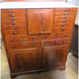 An Edwardian mahogany dental cabinet, the upper section having a central flap front, with a twelve