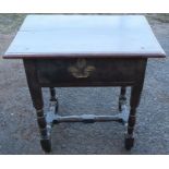 An early 18th century oak side table, fitted with a deep frieze drawer, raised on turned legs,