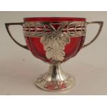 A WMF two handled sugar basket, having mistletoe decoration, with associated ruby glass liner,