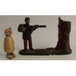 A Creedmoor painted metal novelty money box, formed as a rifleman shooting at a tree, height 7ins,