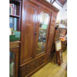 A Victorian mahogany two door wardrobe with central mirror panel, fitted with two hanging spaces