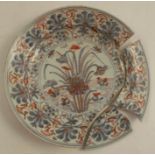 An Oriental plate, decorated in red, blue and gold with flowers, af, diameter 8.5ins - Broken to rim