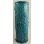 A Burmantofts Faience stick stand, decorated with bamboo and flowers in a blue glaze, numbered to
