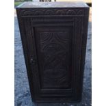 An antique oak cupboard, with carved panel door and stiles, width 17.25ins x depth 8ins x height