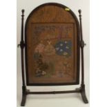 A table top oak swing frame fire screen, with tapestry panel of ladies in a garden, height 23ins