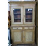A 19th century glazed cabinet over cupboard, the upper section fitted with a pair of glazed doors
