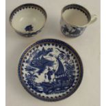 An associated trio set, comprising a Worcester tea bowl and saucer, decorated with the fisherman