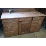 A late 19th century pine cupboard dresser, having a central drawer over a cupboard flanked by four