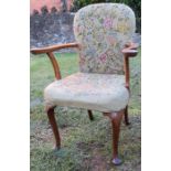 A Queen Anne style walnut open armchair, raised on cabriole front legs, with tapestry back and seat