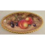 A Royal Worcester oval shaped dish, with a gadroon border decorated with hand painted fruit by