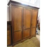 An Edwardian mahogany suite of bedroom furniture, comprising a gentleman's three door press